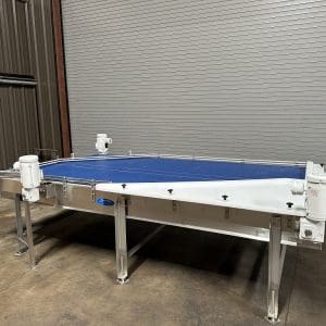 NEVER INSTALLED 2020 Laughlin 6' x 12' Stainless Reflow Surge Accumulation Table, Serial #11010, 2020 Year of MFG, NEVER INSTALLED, (3) Units Available, Stainless Construction, Reflow Surge Accumulation, Size 6' Wide x 12' Long, Plastic Intralox Type Belting, (2) 30" Belts, (1) 6" Center Belt, (1) 3.25" Infeed Bottle Transfer Conveyor with Drive, UHMW Adjustable Guides, Stainless Adjustable Side Rails, 40” Belt Elevation, Stainless Legs, Stainless Floor Levelers, (3) 1 HP Drives, 1760 RPM, All Drives have Hazardous Ratings, Electrical 230/460 Volt / 60 HZ / 3 Phase / 3/1.5 AMPS, Shipping Dimensions: 148" Long x 98" Wide x 54" High. This reflow surge accumulation table was purchased new in 2020 and never installed. This item can be inspected at our Used Packaging Equipment LLC Warehouse Facilities located in Caddo Mills, TX. 75135. Please reach out to one of us today to discuss this item in more details or to arrange an onsite inspection.